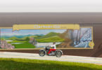 A motorcycle drives in front of a Clarkesville mural.