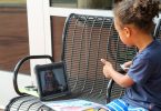 A child attending virtual school outside the Clarke County Public Library.