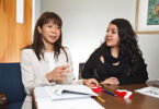 Bernadette Heckman talks with a student in her office.