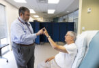 An Alzheimer's patient at UGA's Care center works on small motor skills with a doctor.