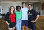 A group of young college students in casual wear smiles at the camera after winning a foundation fellowship from UGA.