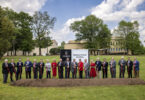 UGA officials and state dignitaries pose with shovels in front of a new sign for the groundbreaking of the new medical education and research building for the School of Medicine on the Health Sciences Campus in Athens, Georgia