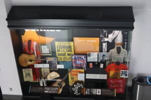 A closeup of a memorabilia box in the Georgia Music Collections. It is filled with signs, clothing, and instruments.